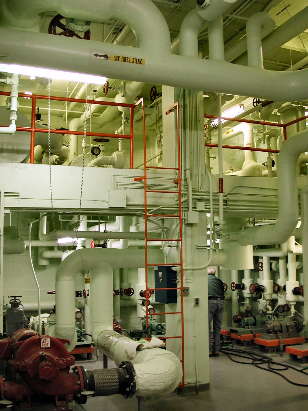 Mechanical room with HVAC piping, valves, and equipment